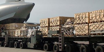 A Tunner cargo loader enters an aircraft to load it.